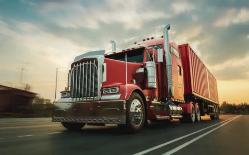 a semi truck driving on a road